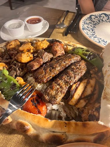 A mixed grill platter served in a cover of bread